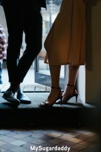 Consejos de estilismo: dos personas, una mujer y un hombre, están el uno ante el otro. Parece que están teniendo un momento muy íntimo. Además, están vestidos muy bien, de forma elegante. 